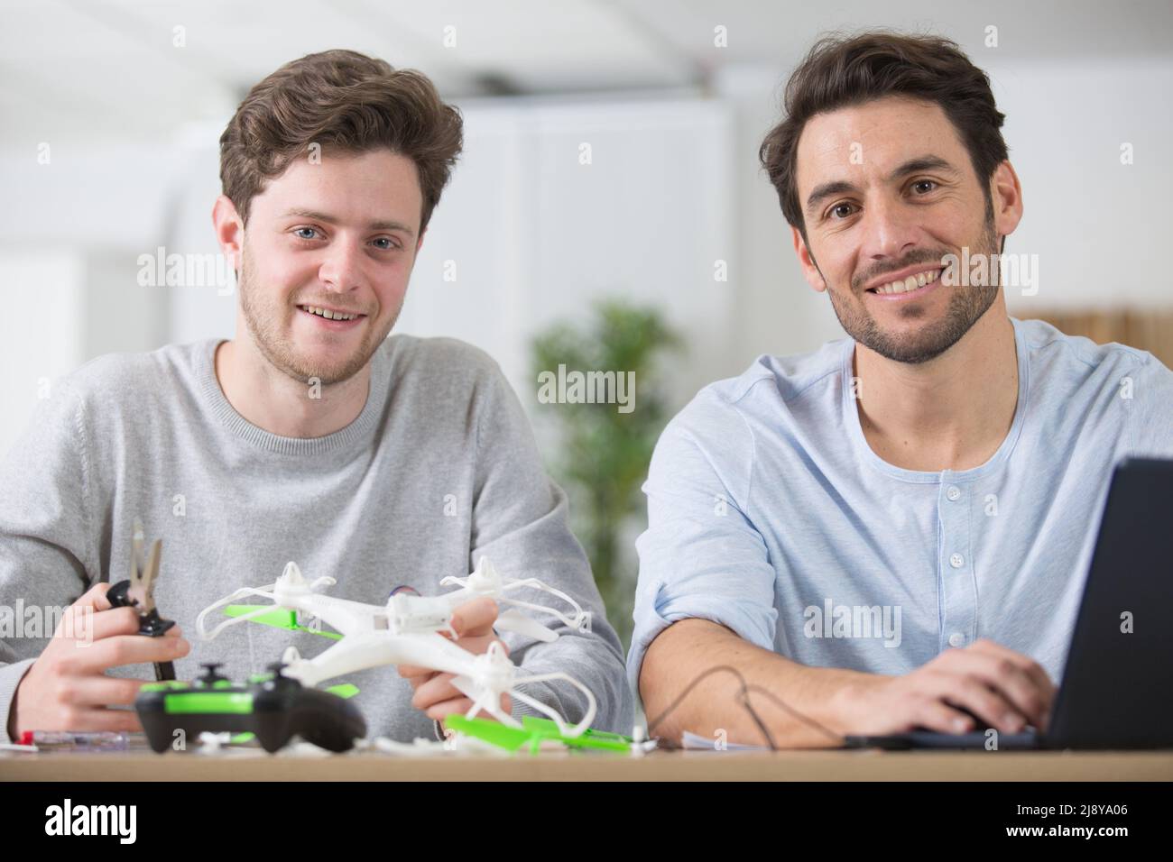 dad and son playing with toy drone Stock Photo - Alamy