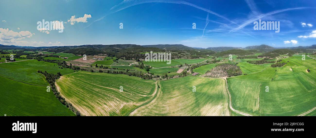 Amazing wide drone panoramic view of green fields and blue sky in Spring time in Penyarroya de Tastavins ,Matarranya Region  Stock Photo