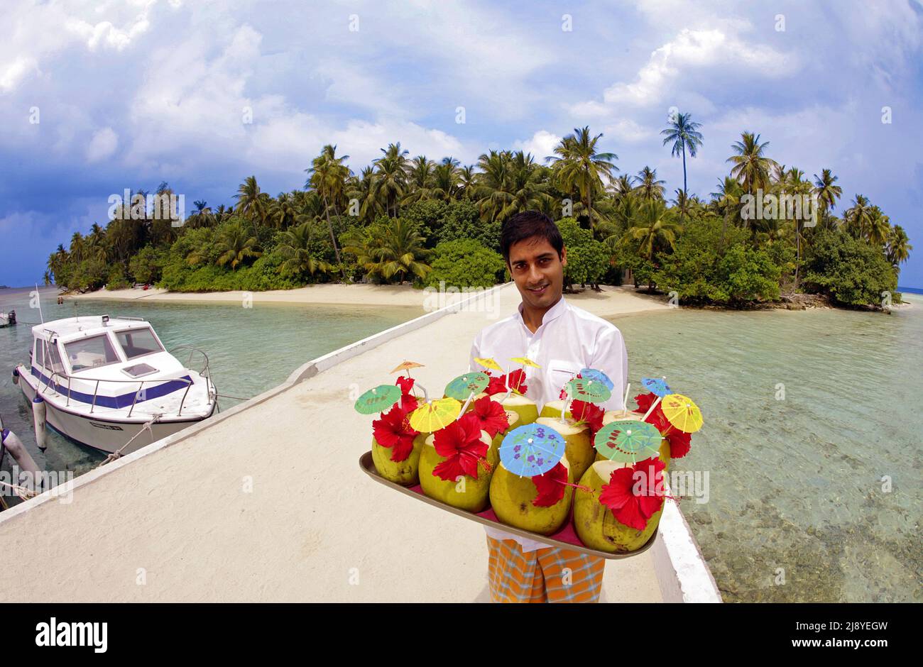 Maldivian waiter serves on the jetty welcome drinks for new arrivals, maldivian island Biyadhoo, South Male Atoll, Maldives, Indian ocean, Asia Stock Photo