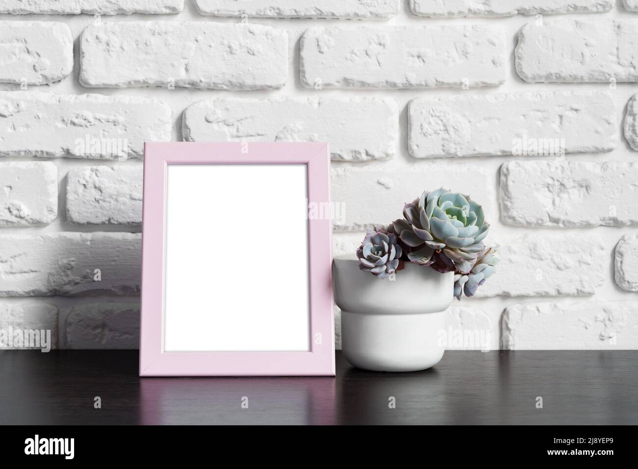 Wooden picture frame on a table with cactus Stock Photo - Alamy