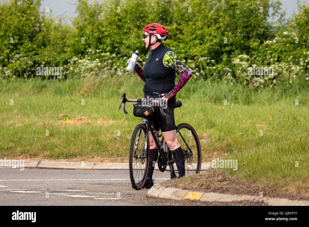 Cyclist stops to take a drink Stock Photo