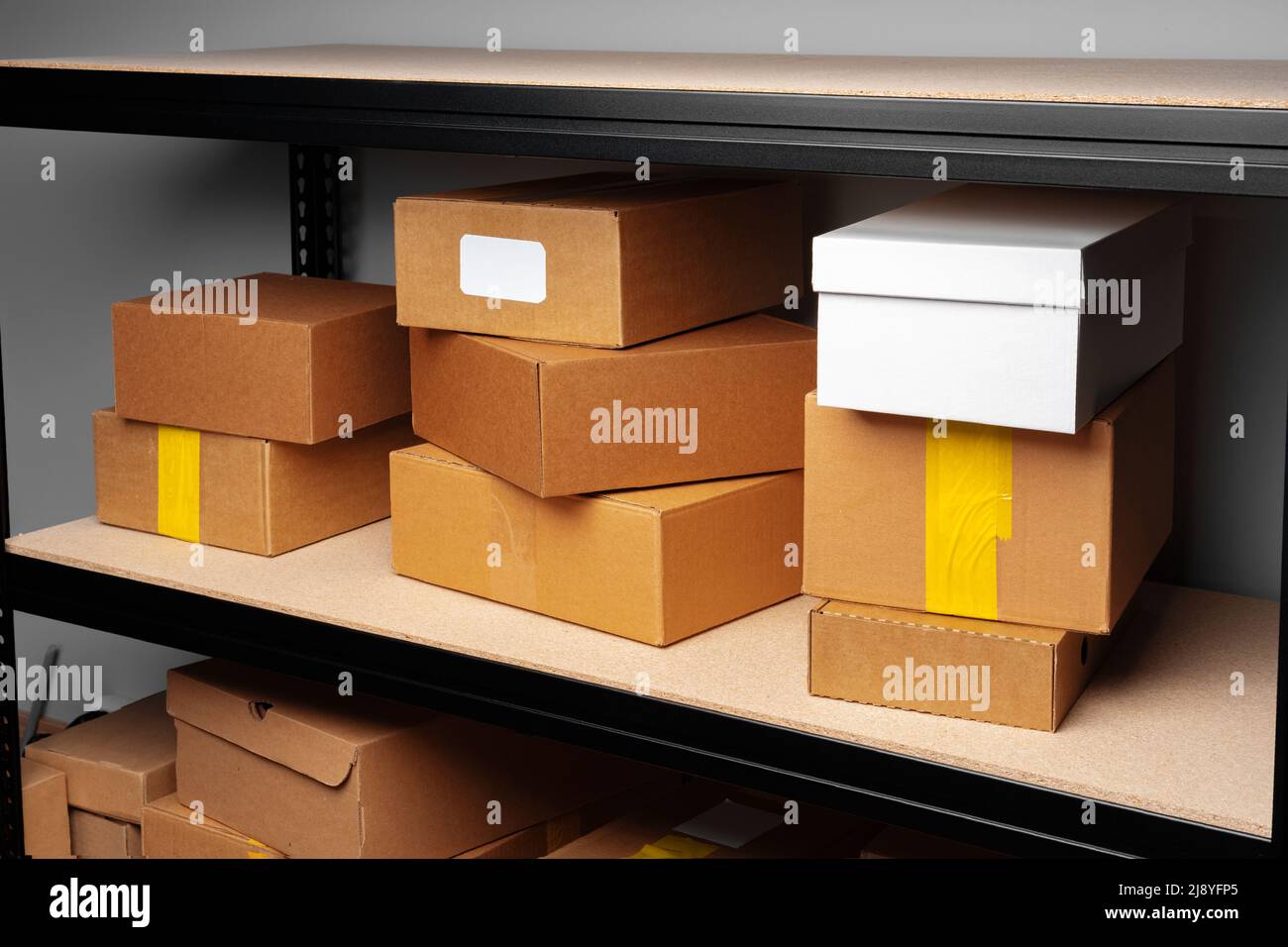Rows of shelves with cardboard boxes in modern warehouse Stock Photo ...