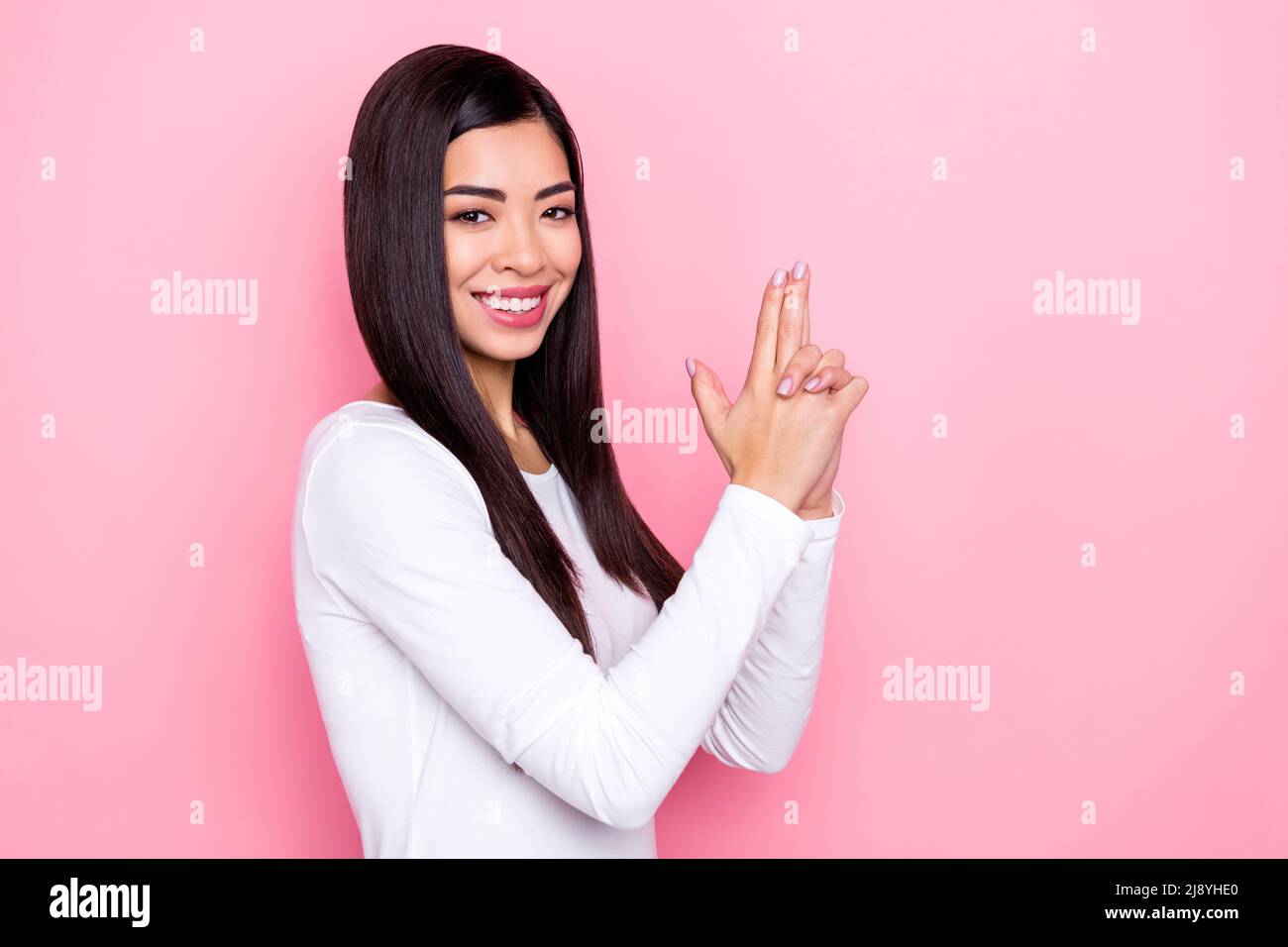 Photo of sweet millennial brunette lady hands gun wear white shirt ...