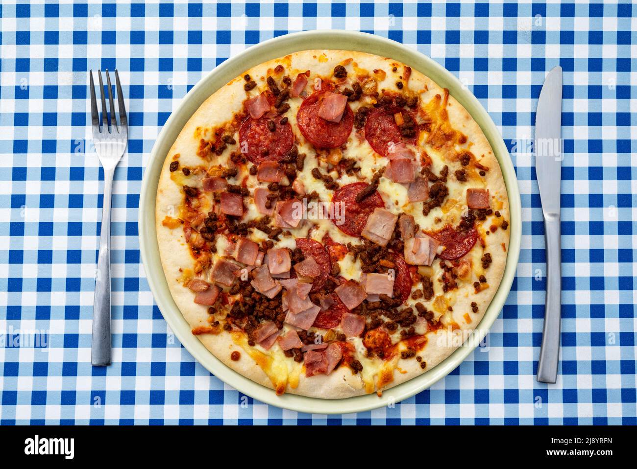 Meat feast shop brought pizza Stock Photo