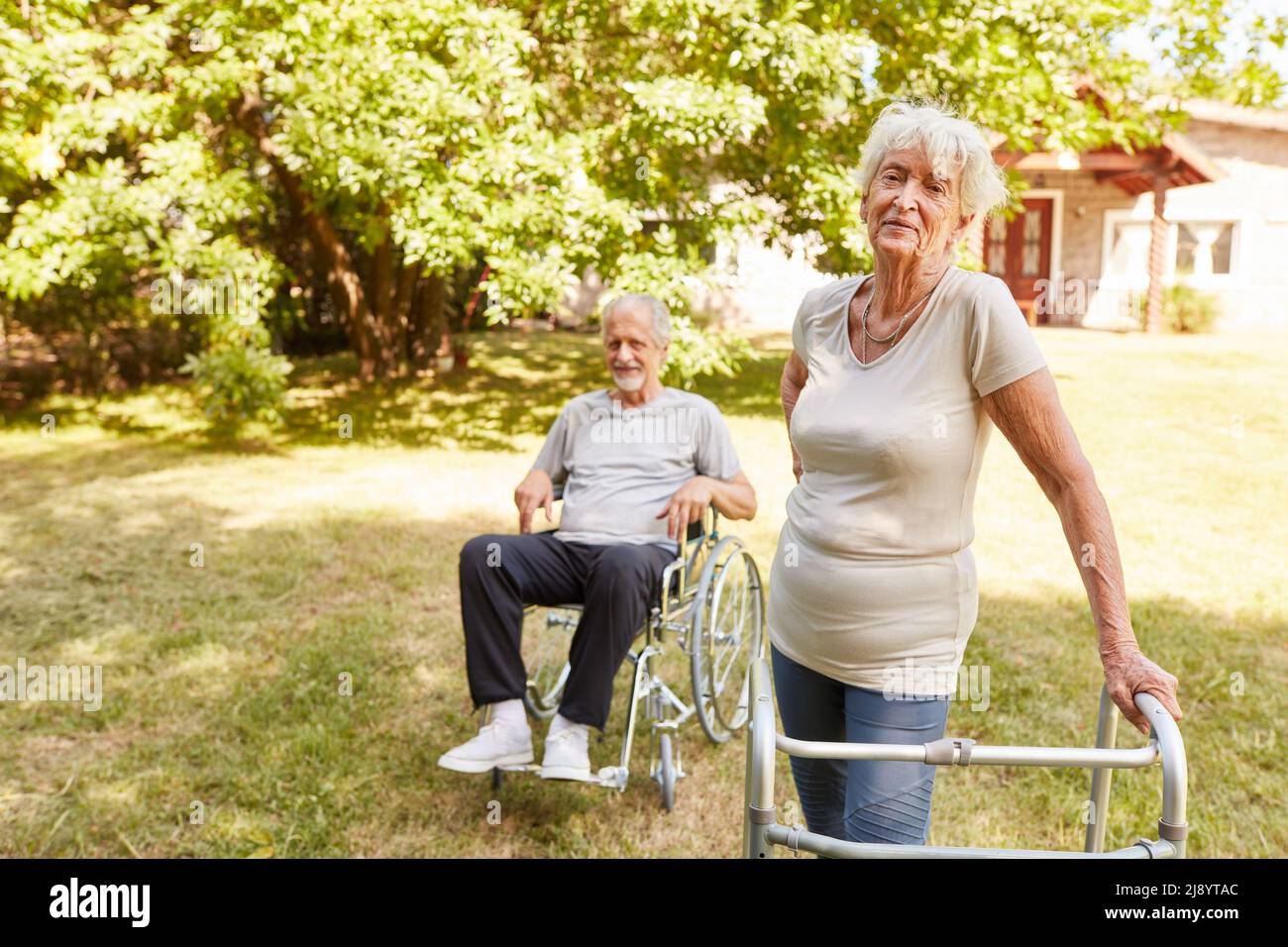 Senior in wheelchair and senior woman with walker do mobility training