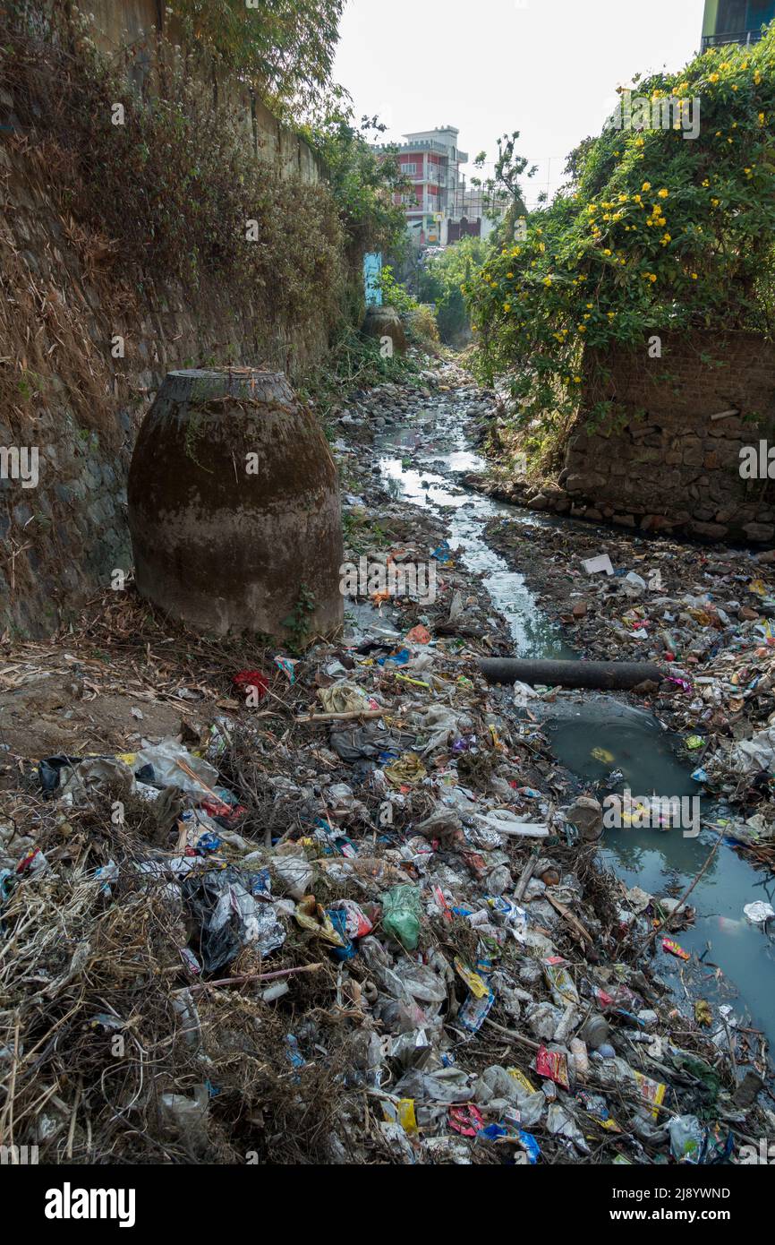 A sewer full of plastic and toxic waste flowing in open. Dehradun, uttarakhand India. Stock Photo