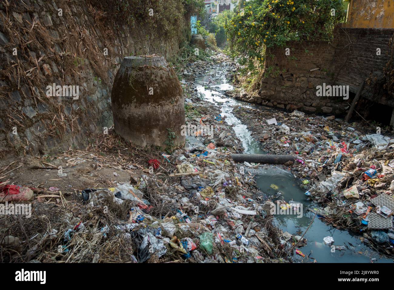 A sewer full of plastic and toxic waste flowing in open. Dehradun, uttarakhand India. Stock Photo