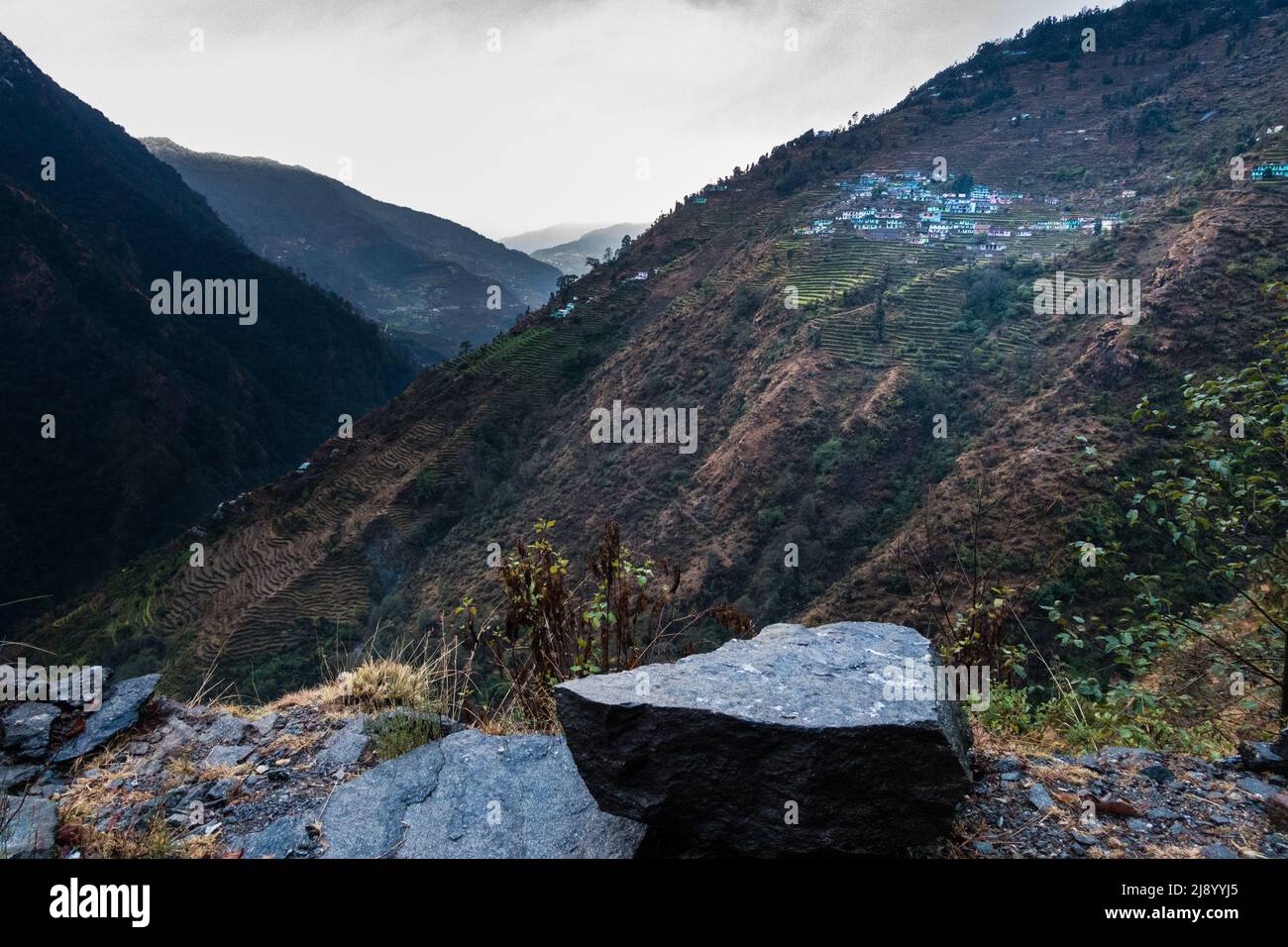 A beautiful shot of distant small village in the mountains of Okhimath district of Chamoli garhwal, Uttrakhand. India. 23rd Jan2022. Stock Photo