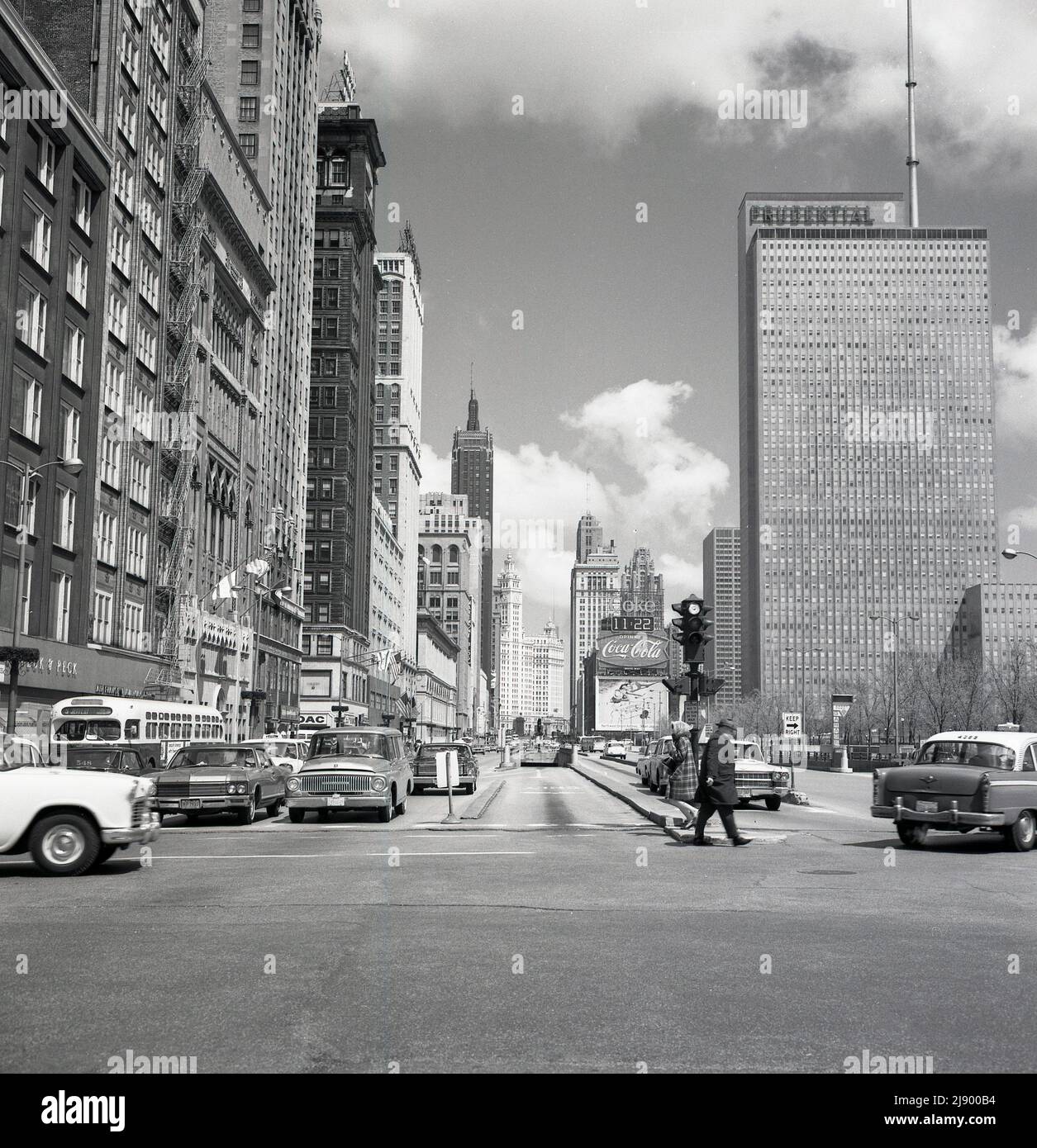 1960s, historical picture by J Allan Cash of N. Michigan Ave, Chicago, USA, showing the Maremont Bldg, Prudential office block and American automobiles of the era. The mid-American headquarters of the US Insurance company Prudential was a 41-story building completed in 1955, and its significance is that it was the first skyscraper built in Chicago since the 1930s Great Depression and the Second World War. The exit and entrance of the underground parking at the Grant Park (South) Garage, a giant municipal parking space with three levels and 1,800 spaces. Stock Photo