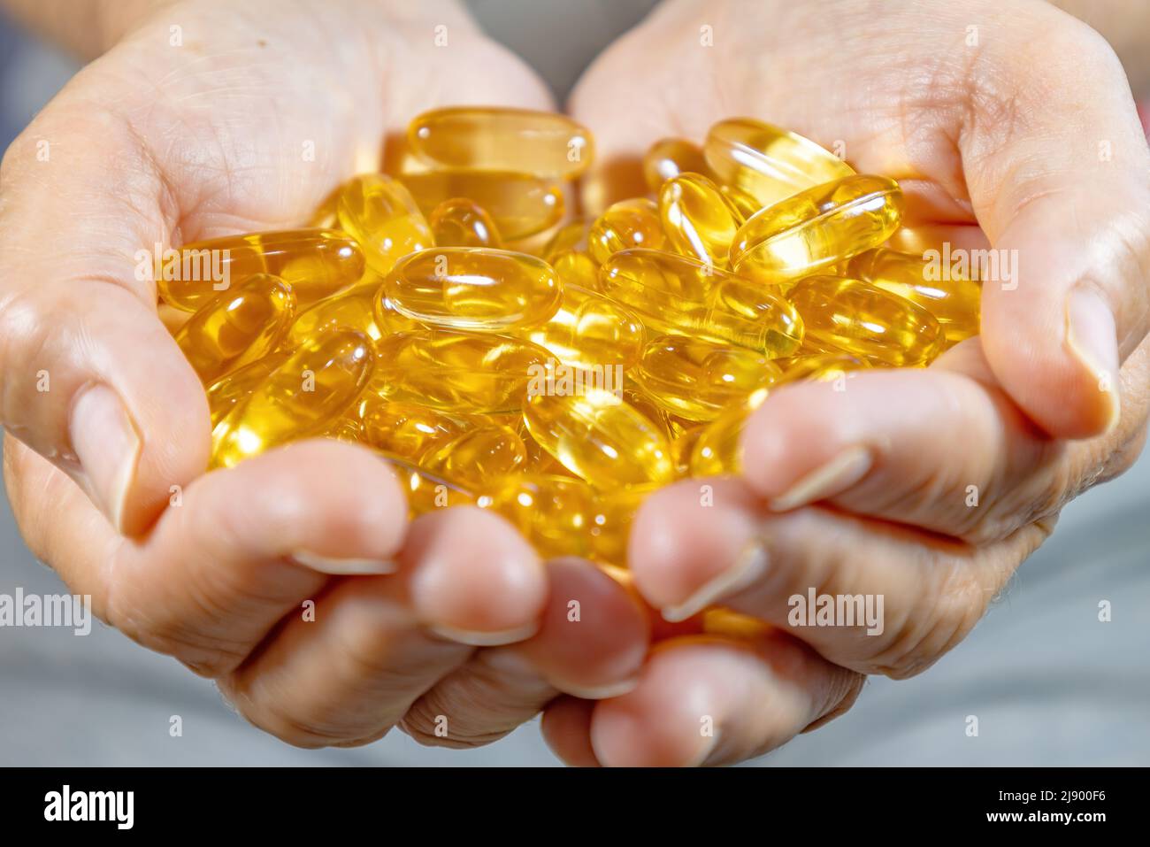 Woman's Hands holding Omega 3 capsules Stock Photo