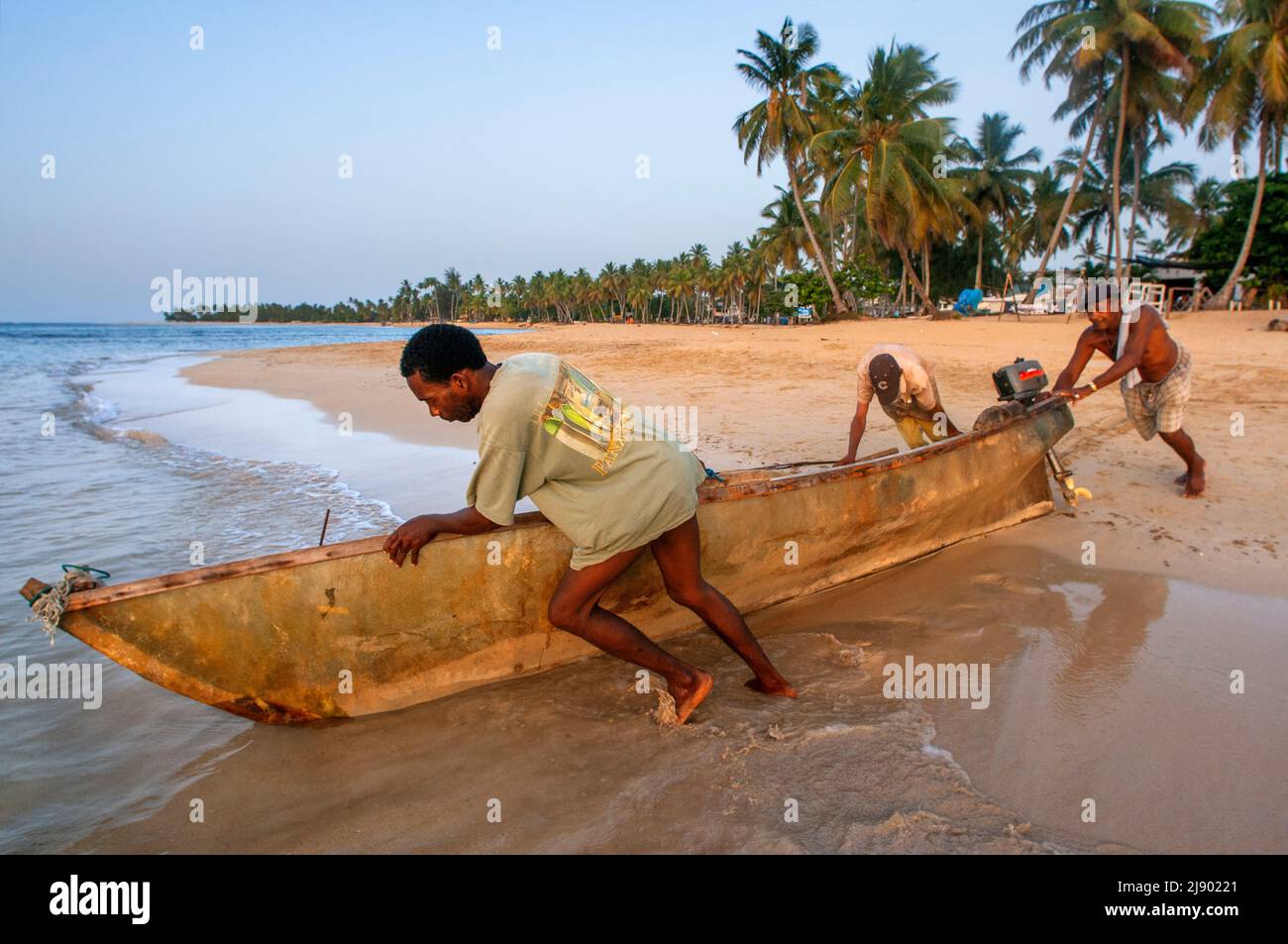 Local fishers in Las Terrenas beach, Samana, Dominican Republic, Carribean, America. Tropical Caribbean beach with coconut palm trees.  This white-san Stock Photo