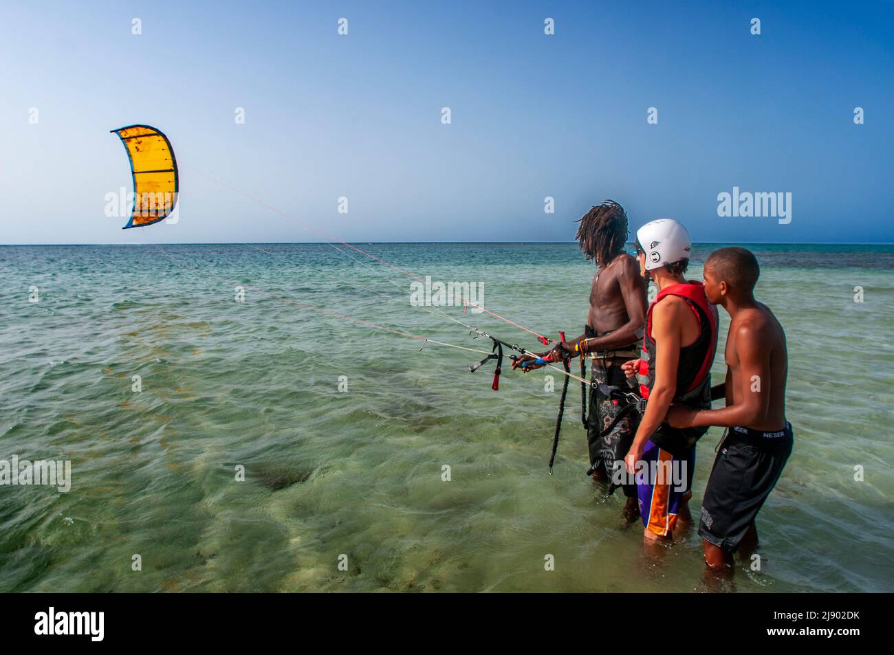 Kitesurf lessons in Las Terrenas beach, Samana, Dominican Republic, Carribean, America. Tropical Caribbean beach with coconut palm trees.  This white- Stock Photo