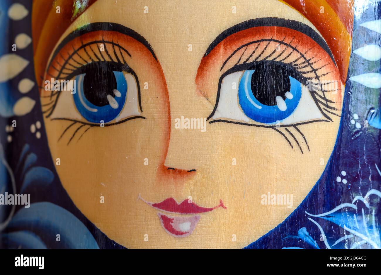Detail of the face of a Matryoshka doll or Russian doll. This nesting doll is comprised of ten stacked figures. The doll is a generic souvenir. Stock Photo