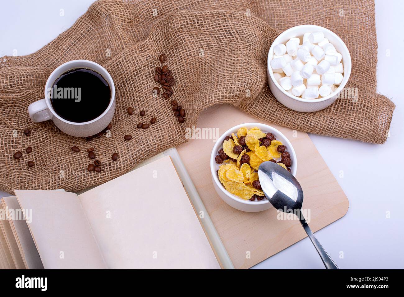 Light breakfast. Cereal with milk, coffee with marshmallows and a