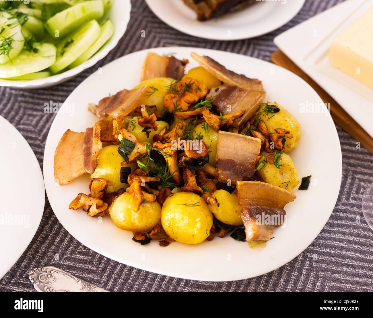 baked potatoes with chanterelles and bacon served with herbs and