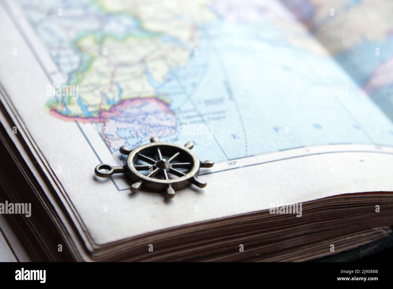 Summer travel idea. Smoll nautical steering wheel and map. Stock Photo
