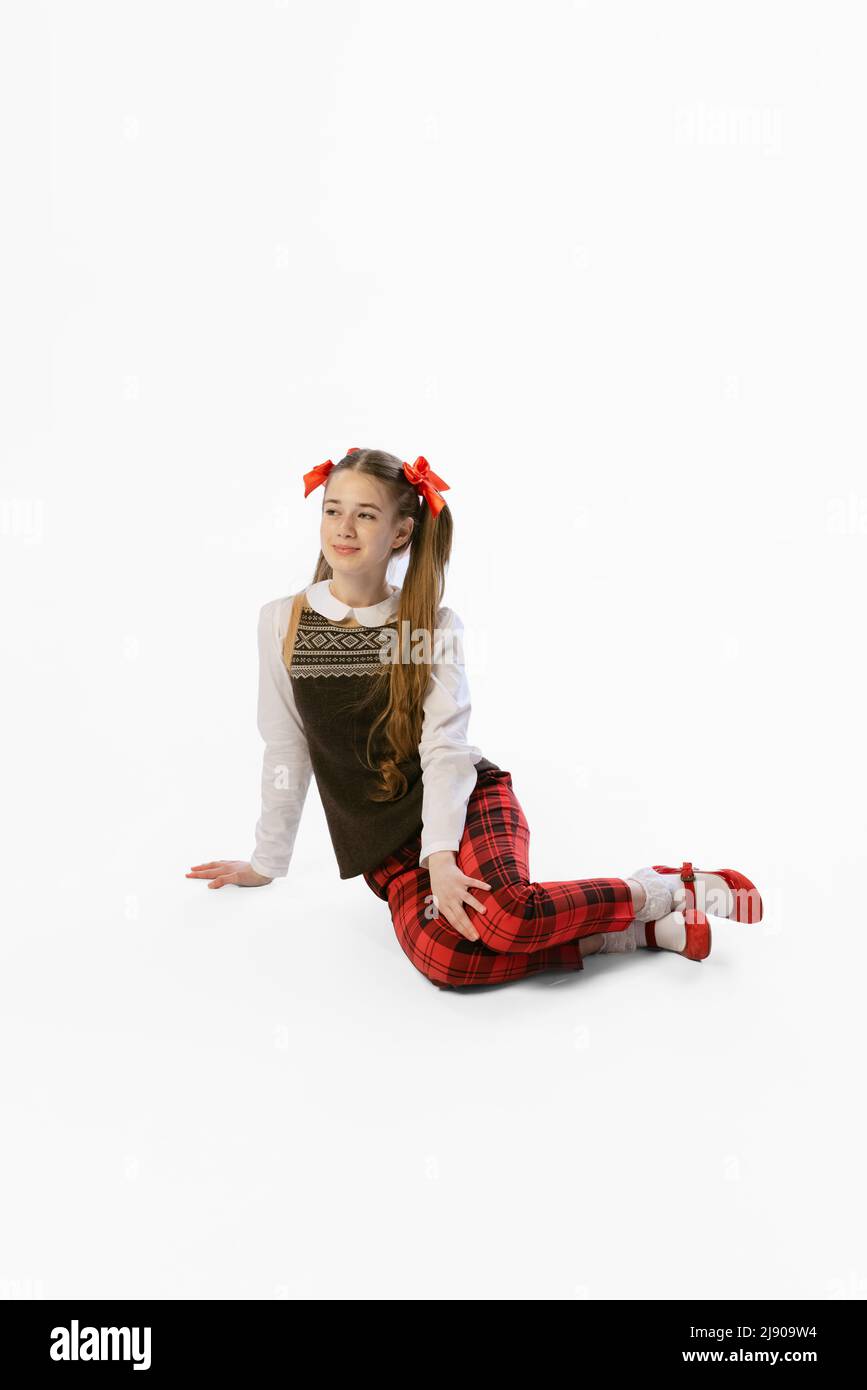 Portrait of beautiful young girl, teen in retro style clothes posing at white studio background. Concept of art, beuty, youth, vintage style, social Stock Photo