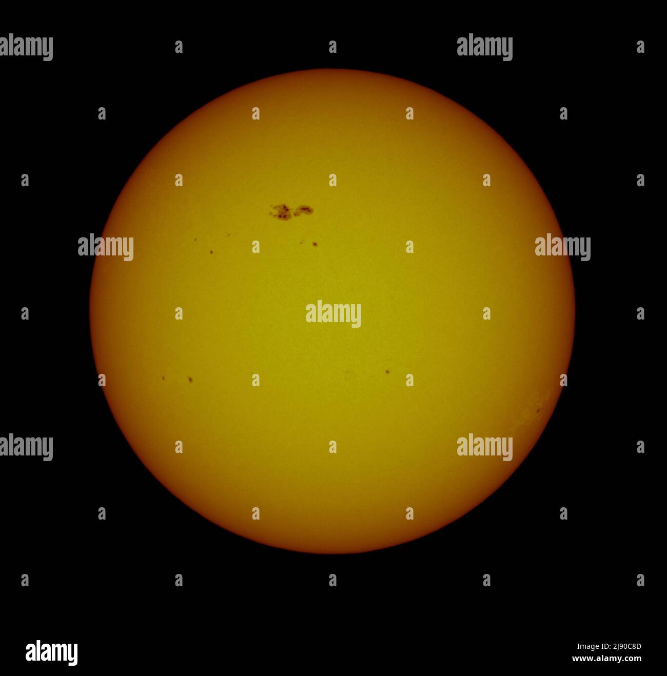 London, UK. 19 May 2022. Groups of sunspots scattered around the surface of the sun with the large group, AR3014 (top left), facing towards Earth and having the potential to unleash solar M class flares. Credit: Malcolm Park/Alamy Live News Stock Photo