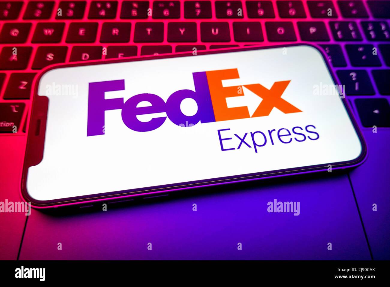 In this photo illustration, a FedEx logo is displayed on the screen of ...