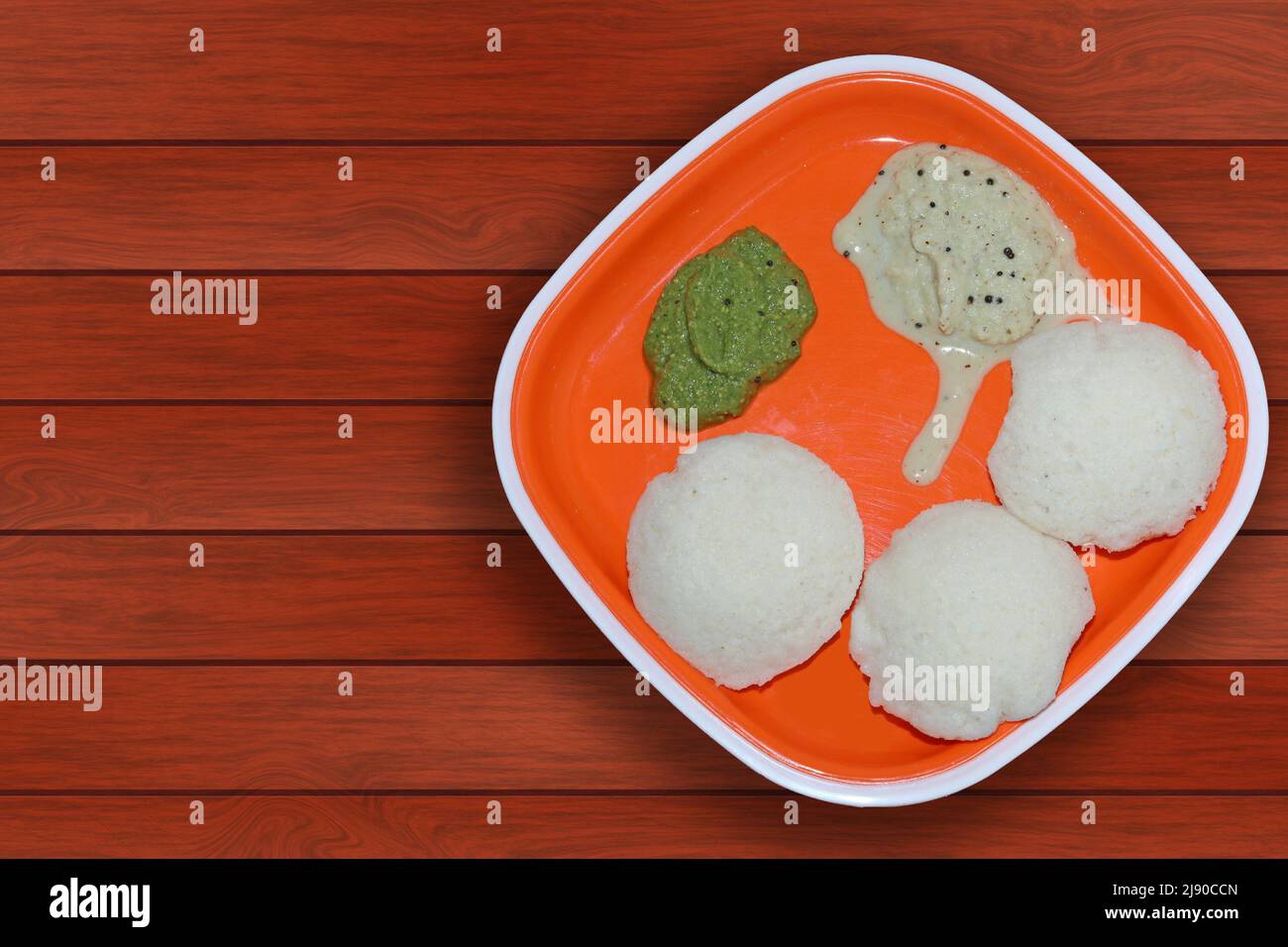 A south Indian breakfast Idli with coconut chutney and coriander mint