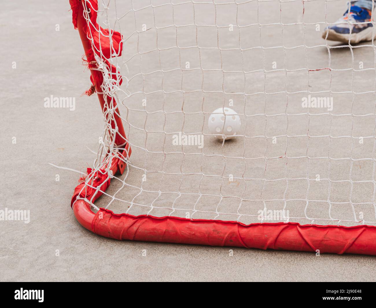 Floorball goal ready for training. Children playing outdoor in spring