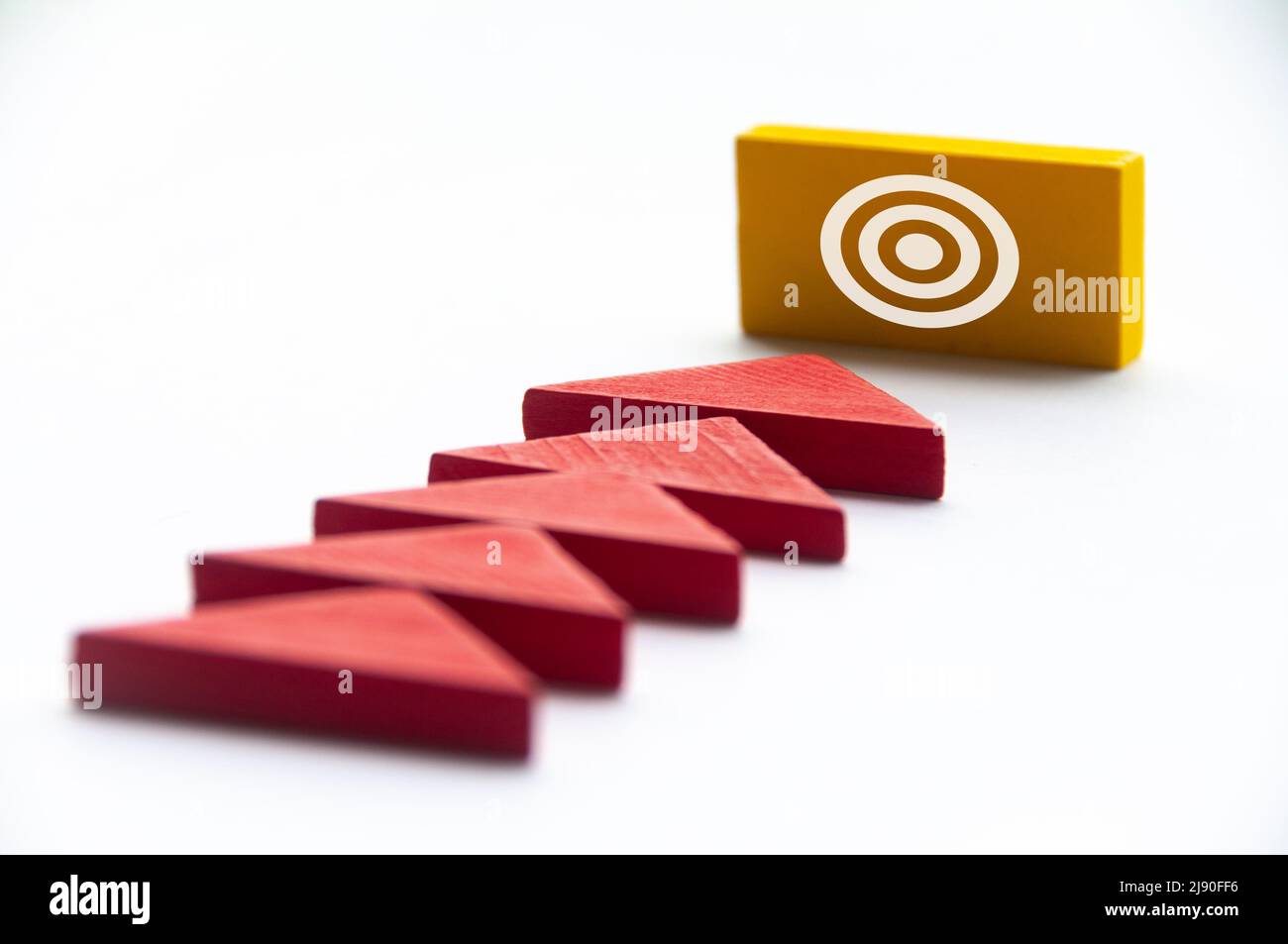 Triangles shape and target symbols on wooden blocks. Goal setting in