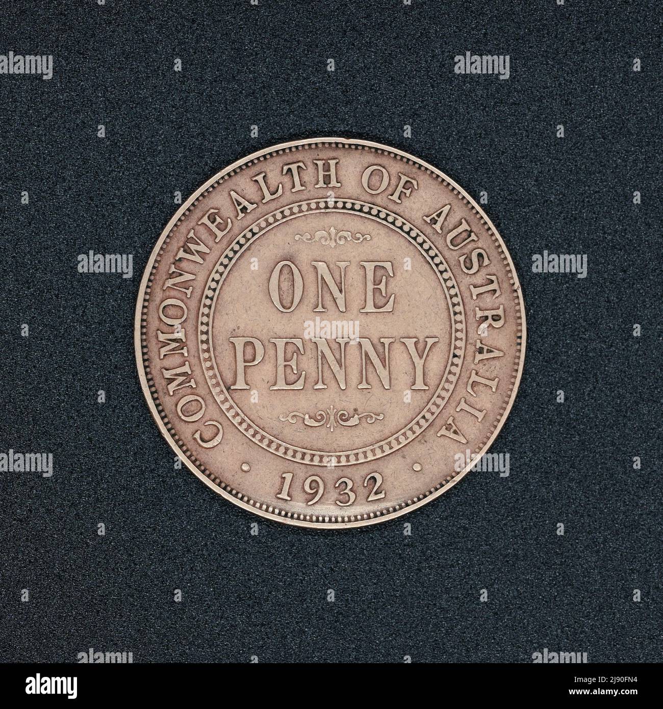Reverse side of an Australian one penny coin coin from 1932, made of bronze, on a black surface Stock Photo