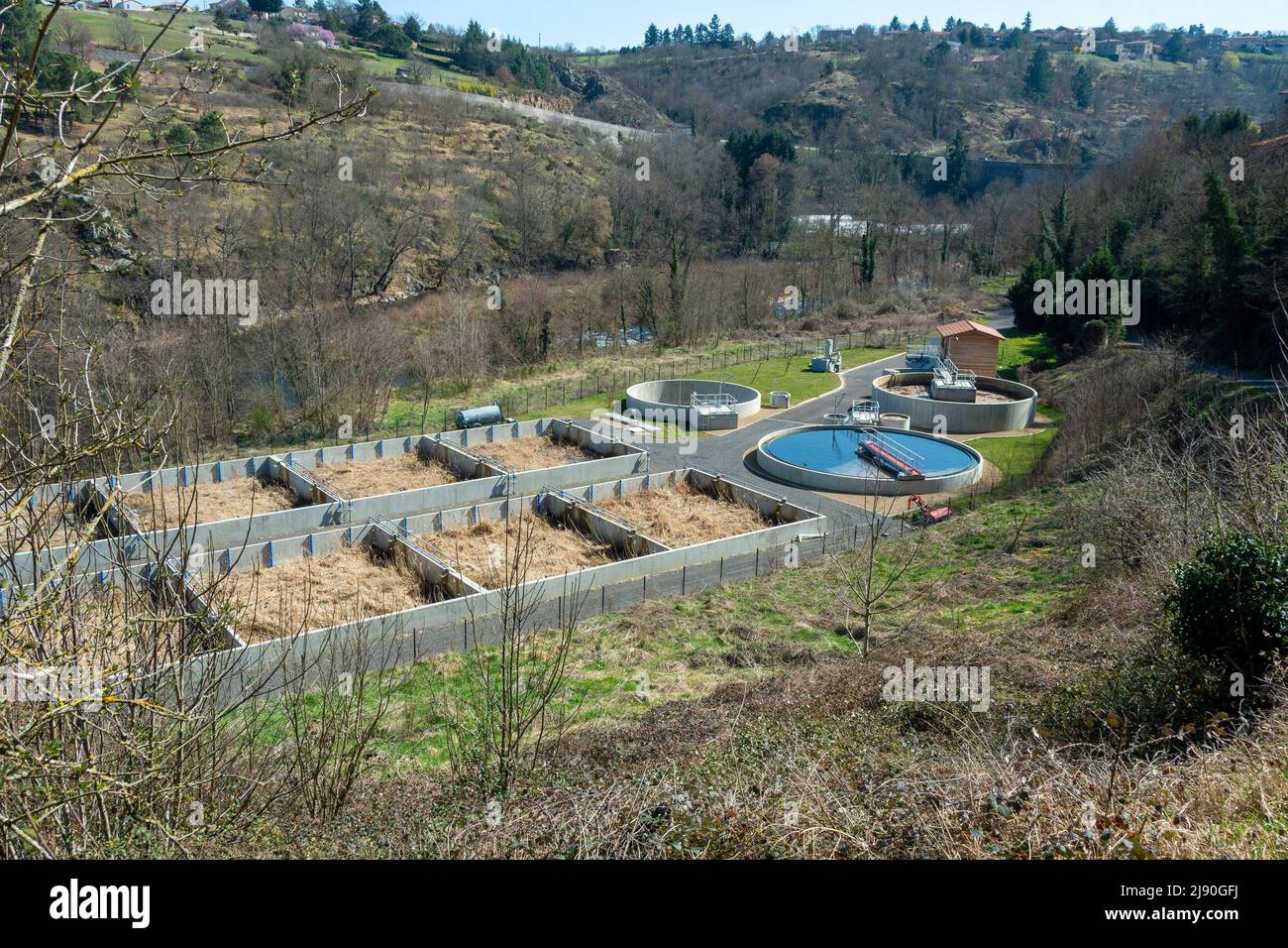 Overview of a modern wastewater treatment facility in a natural setting during daylight, Haute Loire department, Auvergne Rhone Alpes, France, Europe Stock Photo