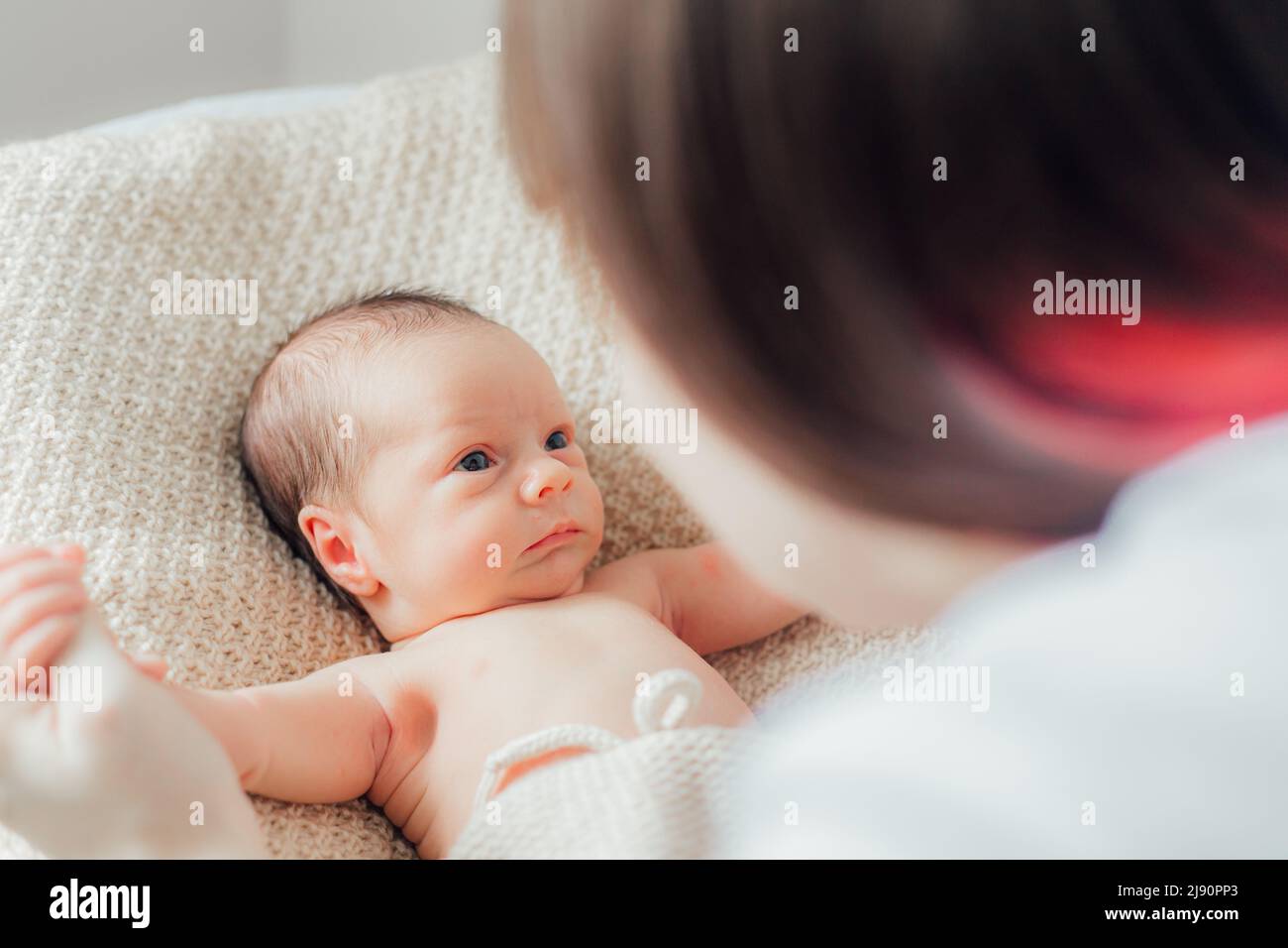 Mom holds the baby in her arms lifestyle . Mother's love for her son. A