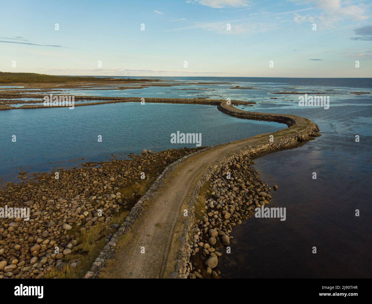 Stone dam-road on Solovki. Road through the White Sea. Big Muksalma Island. Russia, Arkhangelsk region Stock Photo