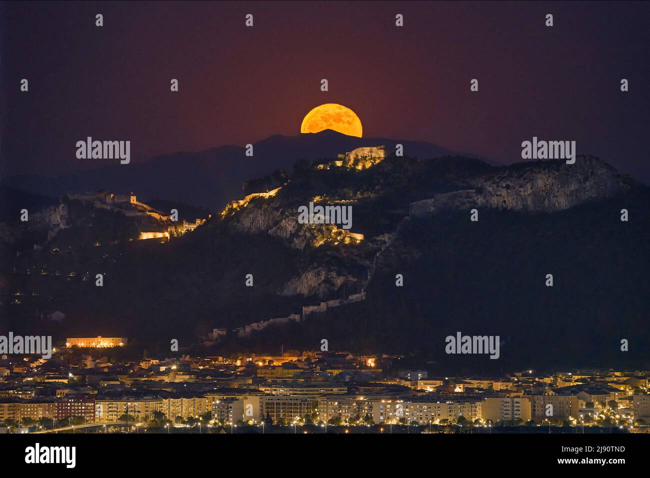 Full moon behind Xativa castle (Valencia - Spain) Stock Photo
