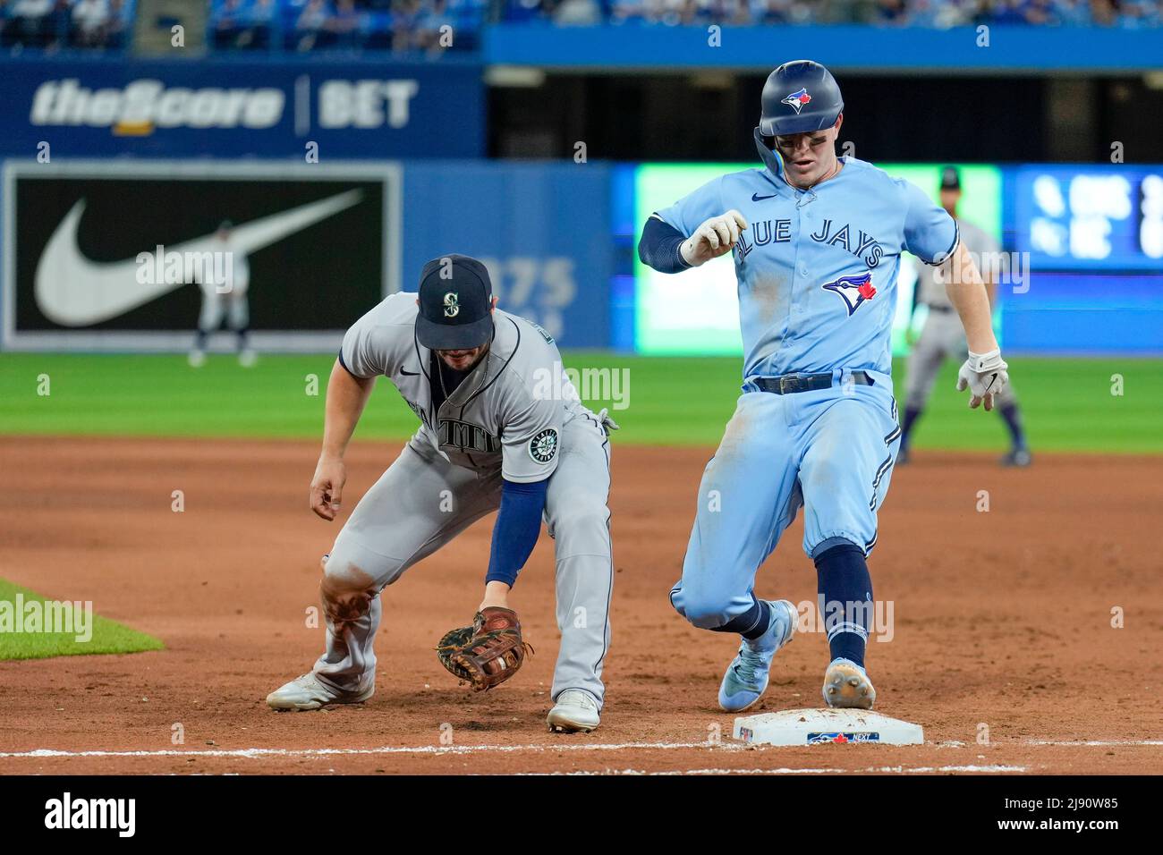 Seattle Mariner infielder Ty France (23) attempt tag out Toronto Blue Jay infielder  Matt Chapman(26) during an MLB game between Seattle Mariners and Stock Photo