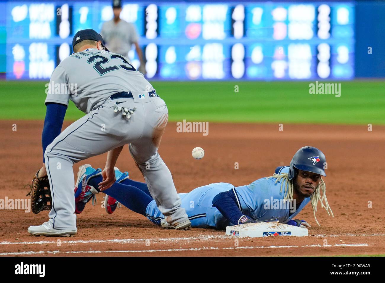 Seattle Mariner infielder Ty France (23) attempt tag out Toronto Blue Jay outfielder Raimel Tapia (15) during an MLB game between Seattle Mariners and Stock Photo