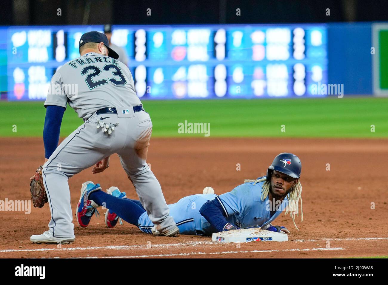 Seattle Mariner infielder Ty France (23) attempt tag out Toronto Blue Jay outfielder Raimel Tapia (15) during an MLB game between Seattle Mariners and Stock Photo