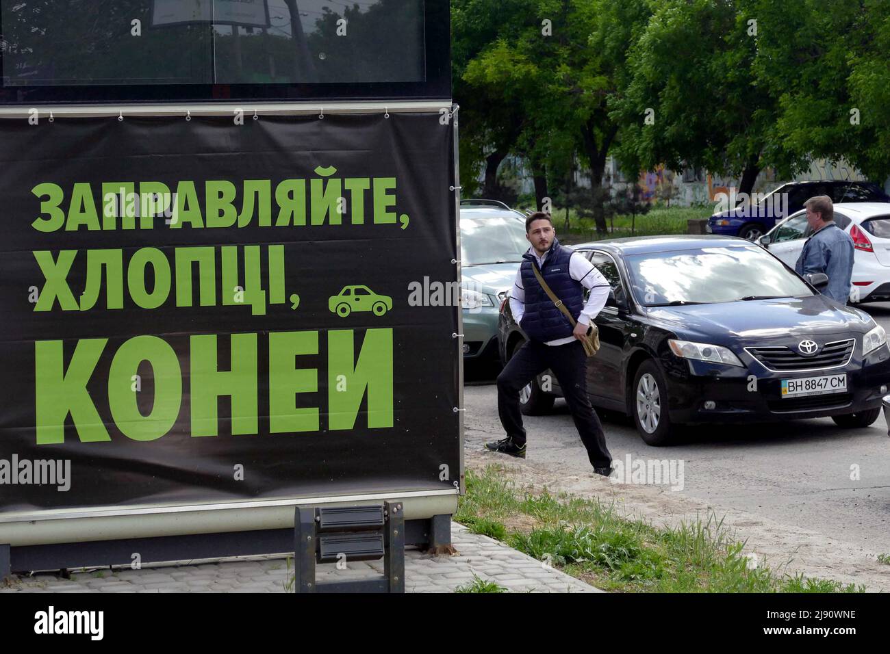 ODESA, UKRAINE MAY 19, 2022 A man steps on the pavement behind a