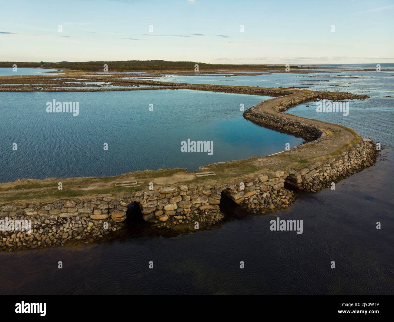 Stone dam-road on Solovki. Road through the White Sea. Big Muksalma Island. Russia, Arkhangelsk region Stock Photo