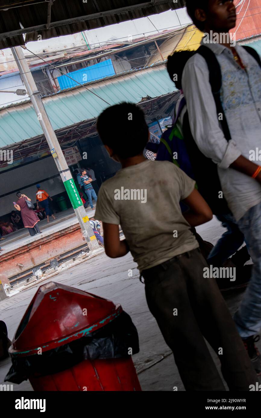 indian child beggar is in a railway station. Concept- child education. Stock Photo