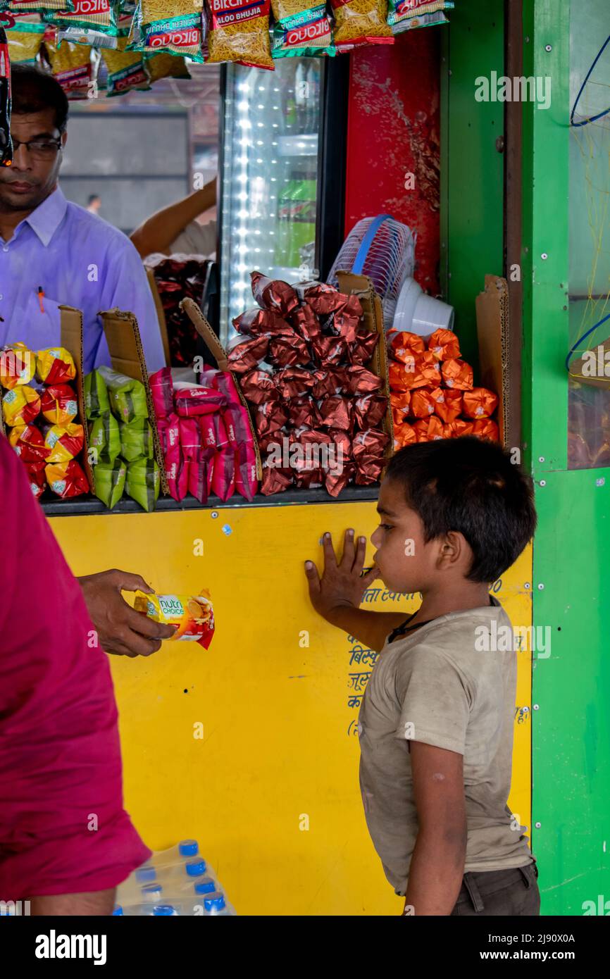 indian child beggar is in a railway station. Concept- child education. Stock Photo