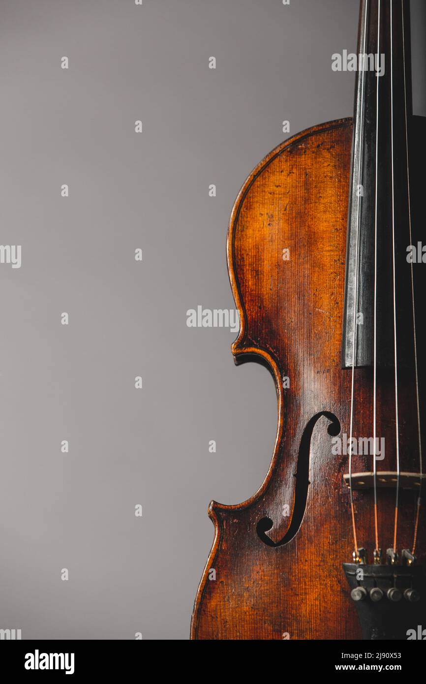 Close up of an antique violin on a neutral grey background Stock Photo -  Alamy