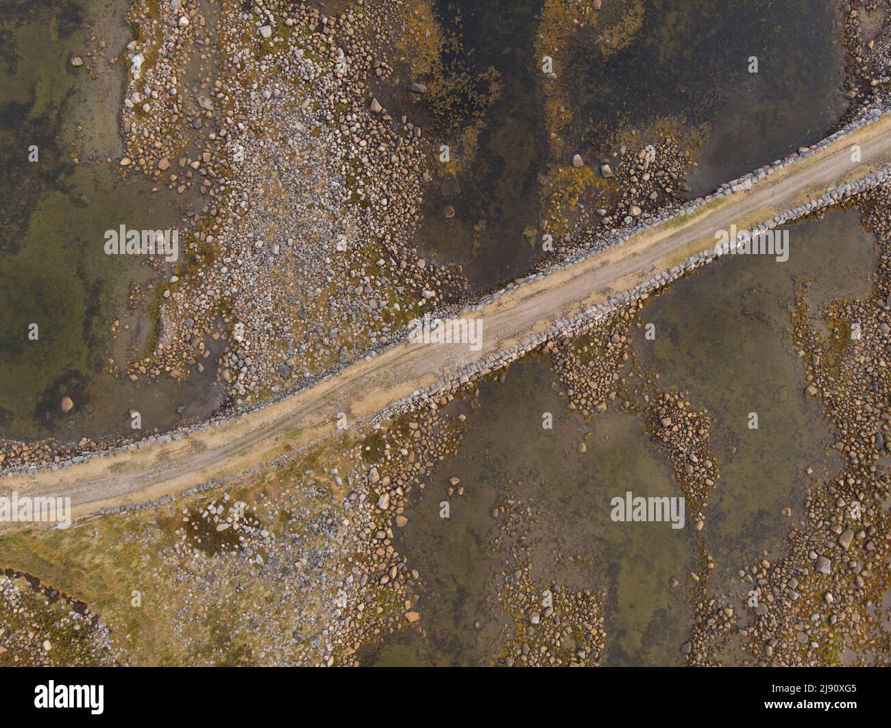Stone dam-road on Solovki. Road through the White Sea. Big Muksalma Island. Russia, Arkhangelsk region Stock Photo