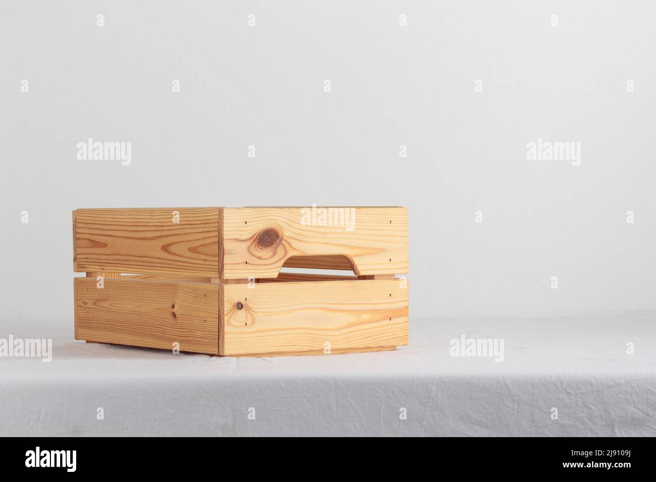 Empty wooden box on a table near white wall Stock Photo Alamy