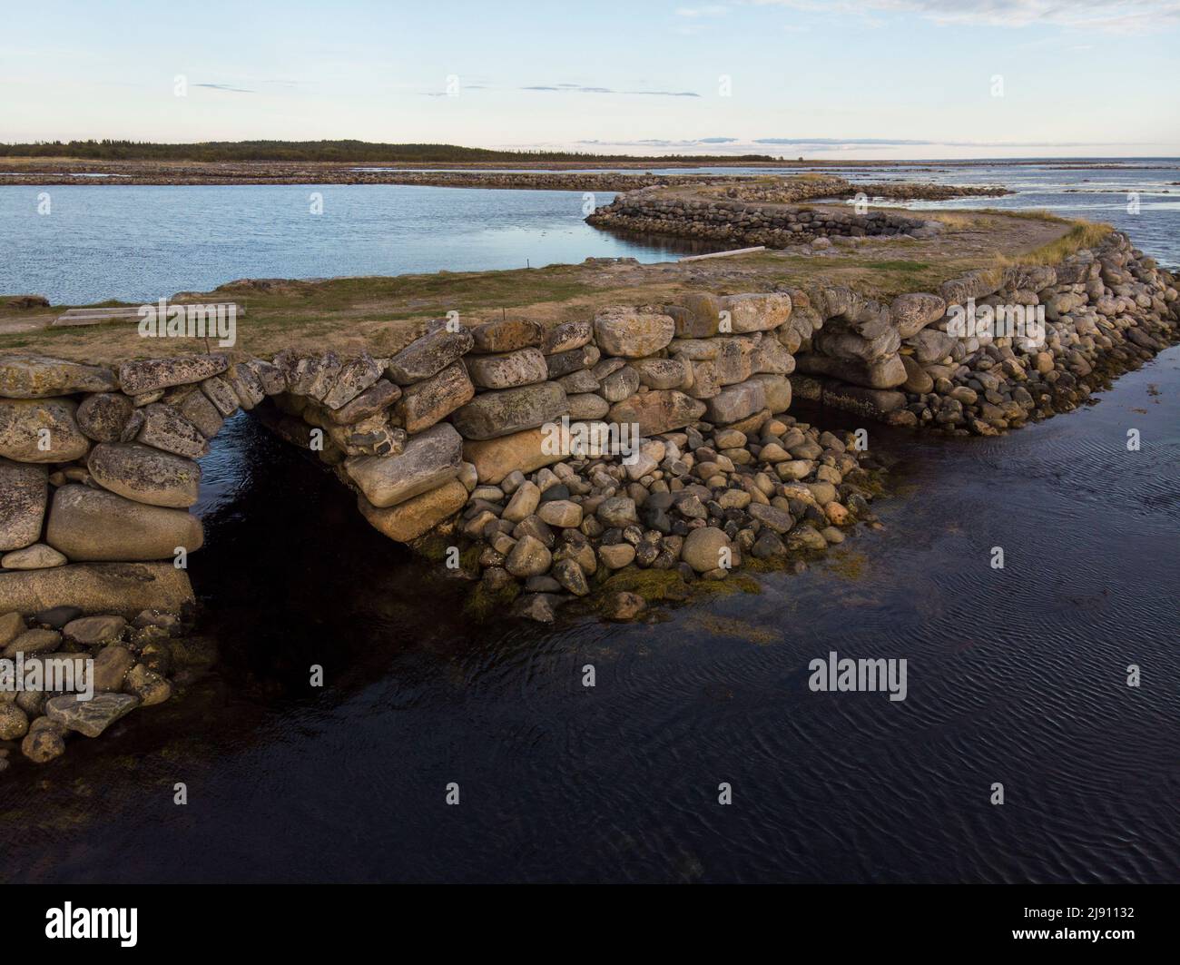 Stone dam-road on Solovki. Road through the White Sea. Big Muksalma Island. Russia, Arkhangelsk region Stock Photo