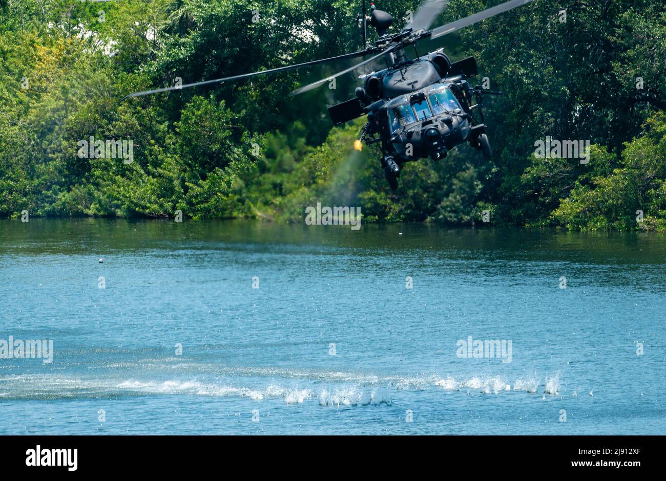 Tampa, United States. 18th May, 2022. U.S. Special Operations Forces commandos perform a simulated attack maneuver in an Army MH-60 helicopter during a public demonstration as part of SOF Week, May 18, 2022 in Tampa, Florida. Credit: SSgt. Alexander Cook/U.S. Air Force/Alamy Live News Stock Photo