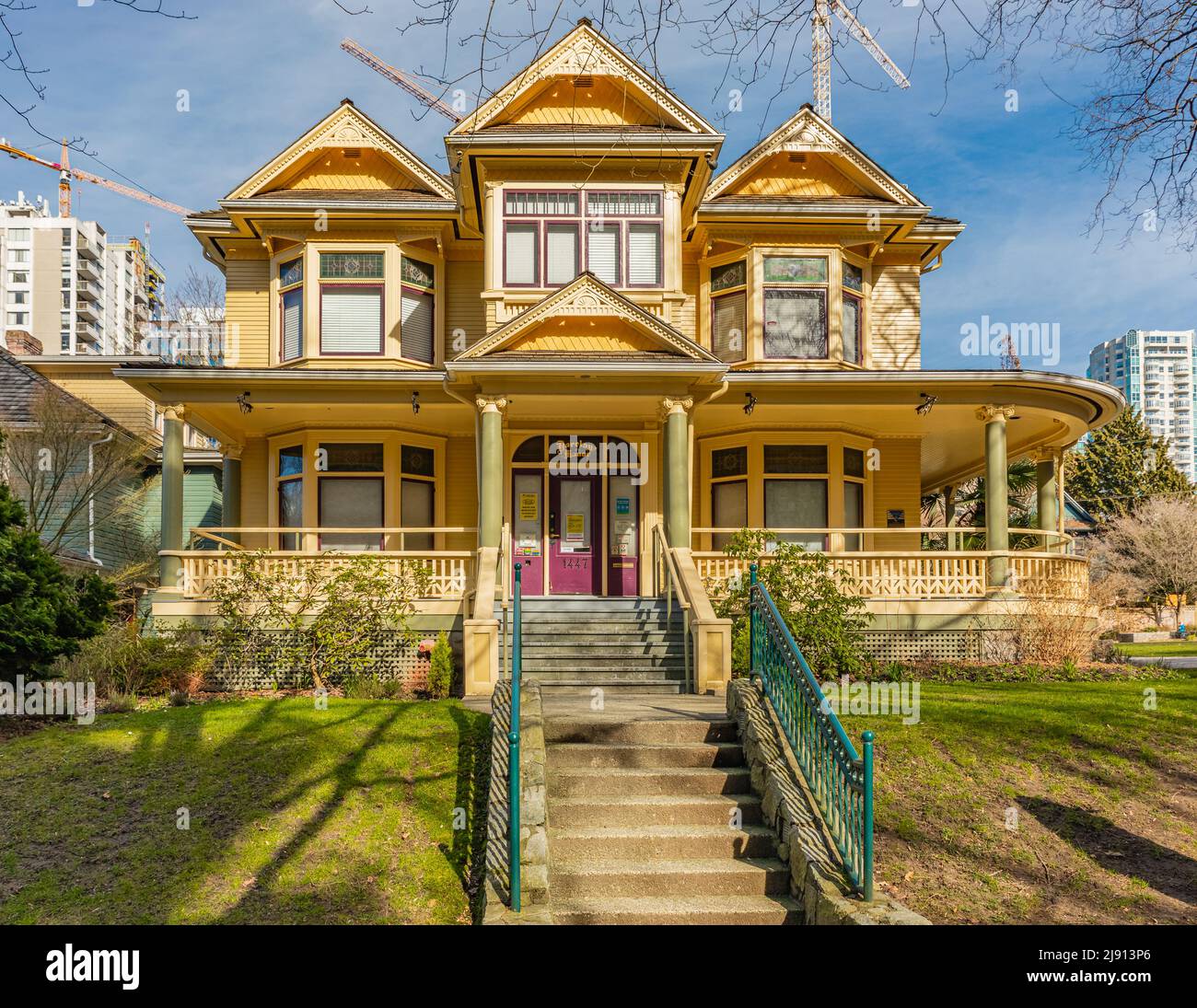 Barclay Manor Home of West End Seniors Network on 1447 Barclay Street in Vancouver. Beautiful old yellow house on the street of Vancouver Canada-March Stock Photo