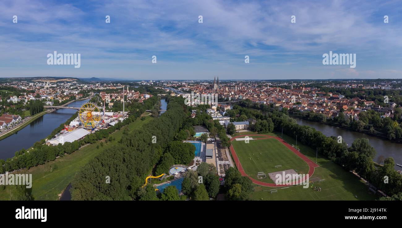 Aerial drone view of the fair Maidult in Regensburg, Bavaria, Germany with ferris wheel, fun rides and beer tents on sunny day Stock Photo