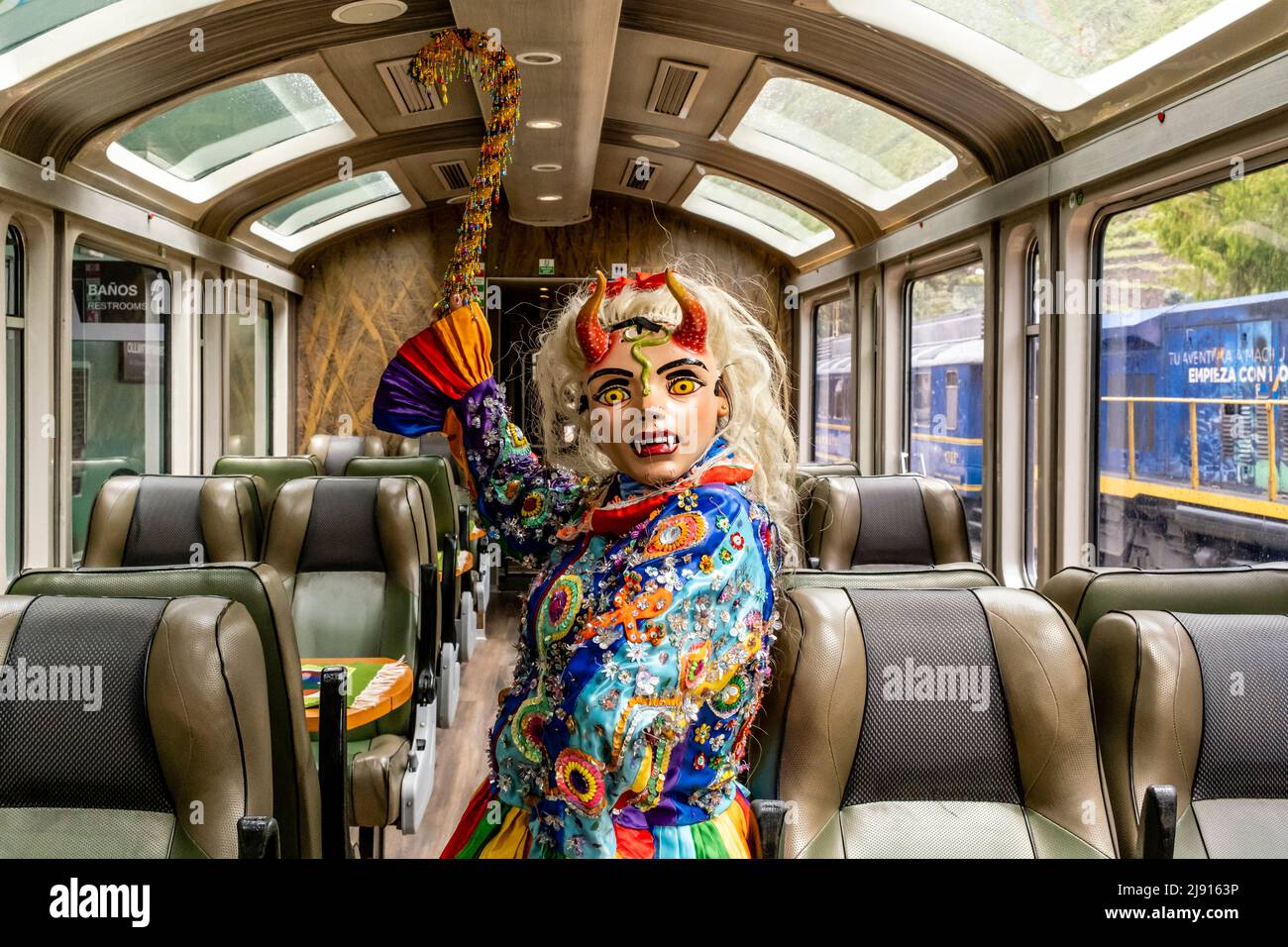 A Peruvian Cultural Show Entertainer Performing Onboard A Train Travelling Between Ollantaytambo and Aguas Calientes Stations, Cusco Region, Peru. Stock Photo