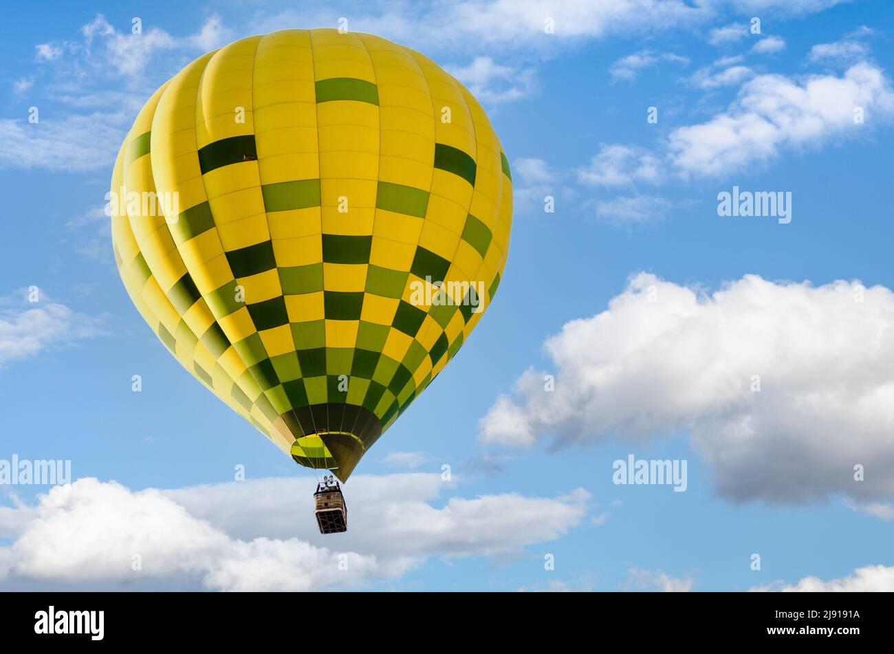 Colorful hot air balloon flying over blue sky Stock Photo - Alamy