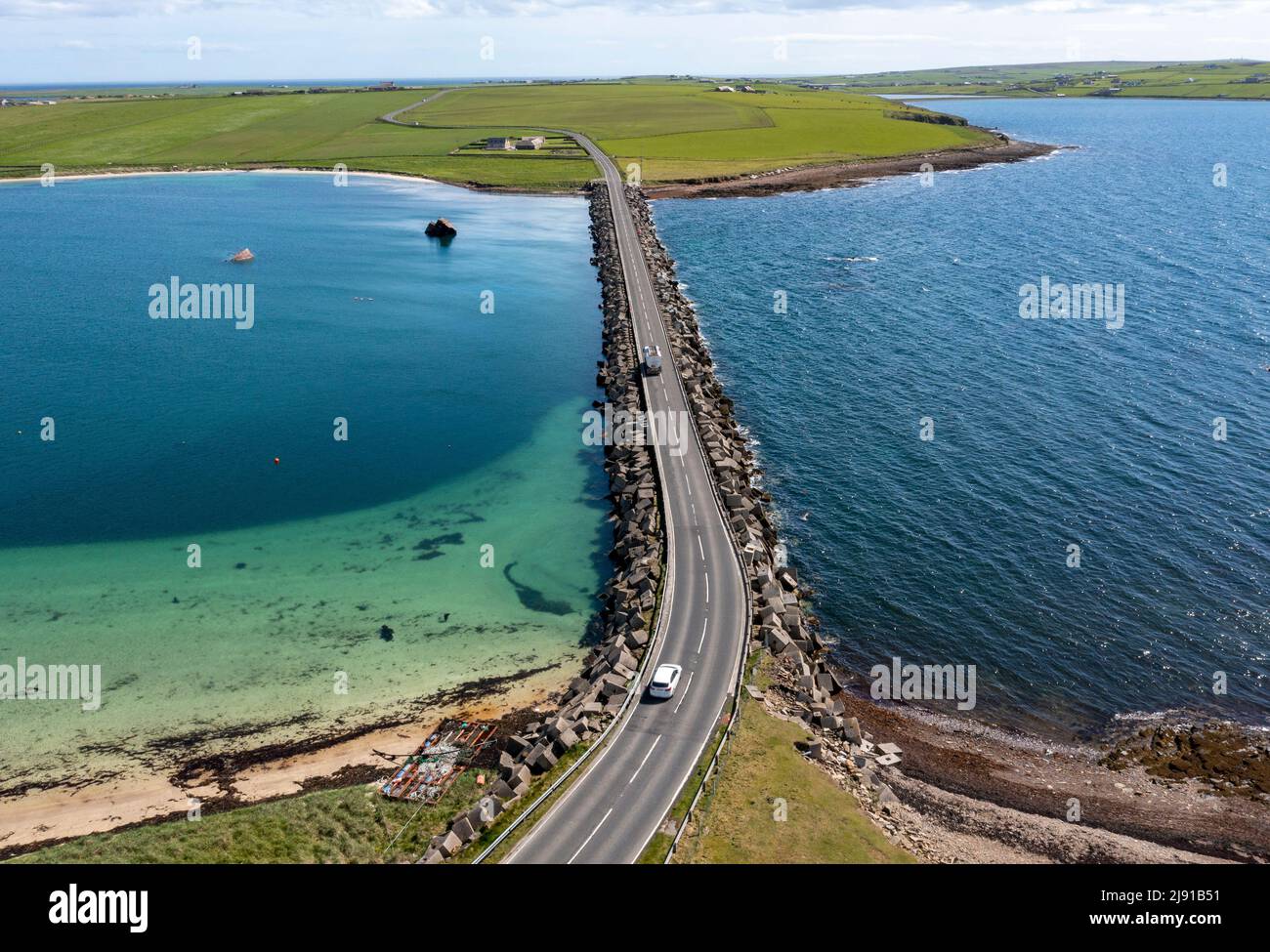 Aerial view of Churchill Barrier No.3 and 'block ship' partially submerged. The barrier links Glimps Holm and Burray, Orkney Islands, Scotland Stock Photo