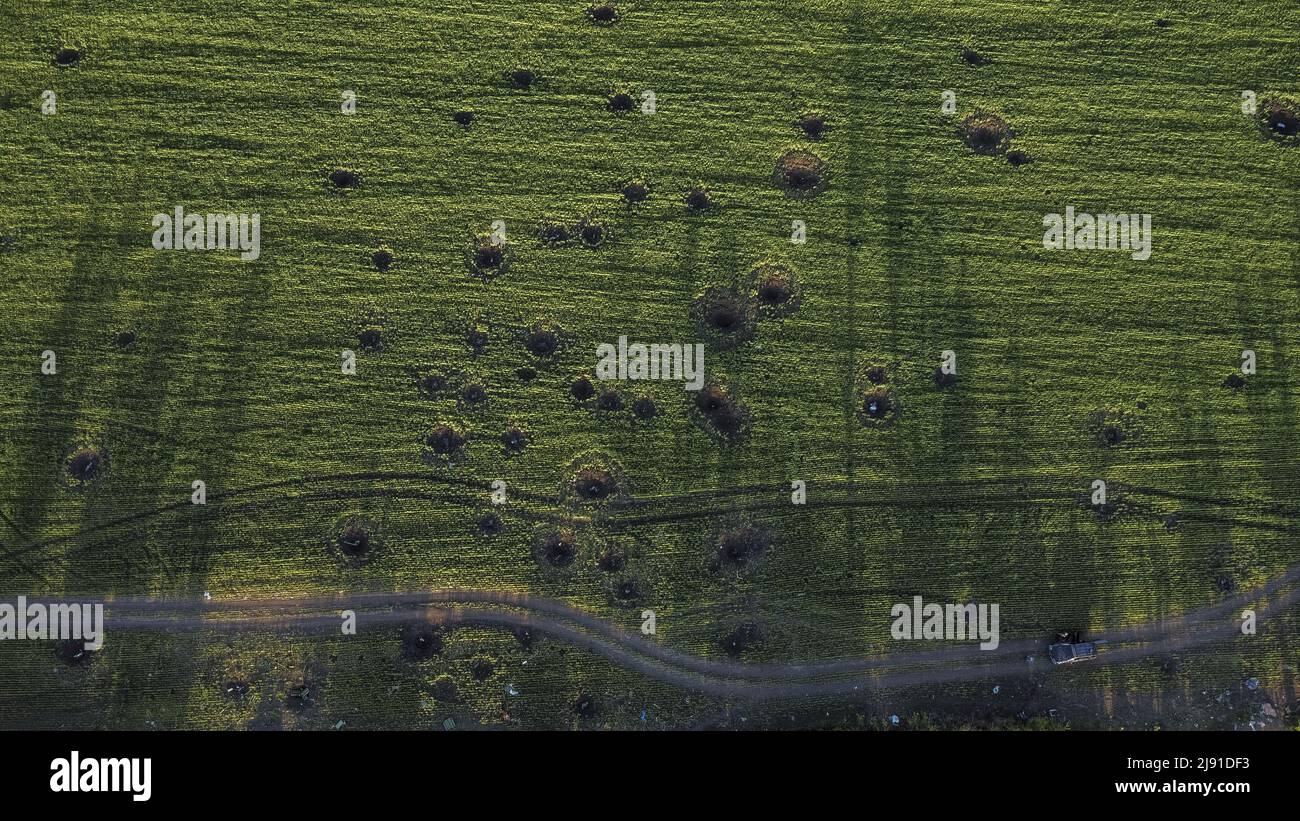 Malaya Rohan, Ukraine. 19th May, 2022. A drone photo showing impact craters are seen near a tree line used by Russians in Malaya Rohan, Ukraine, Wednesday, May 18, 2022. Russians used this tree line to attack traffic on a nearby highway. Finland and Sweden formally submitted applications to join the NATO military alliance early Wednesday, ending the Nordic nations' decades of military neutrality in the wake of Russia's war in Ukraine. Photo by Ken Cedeno/UPI Credit: UPI/Alamy Live News Stock Photo
