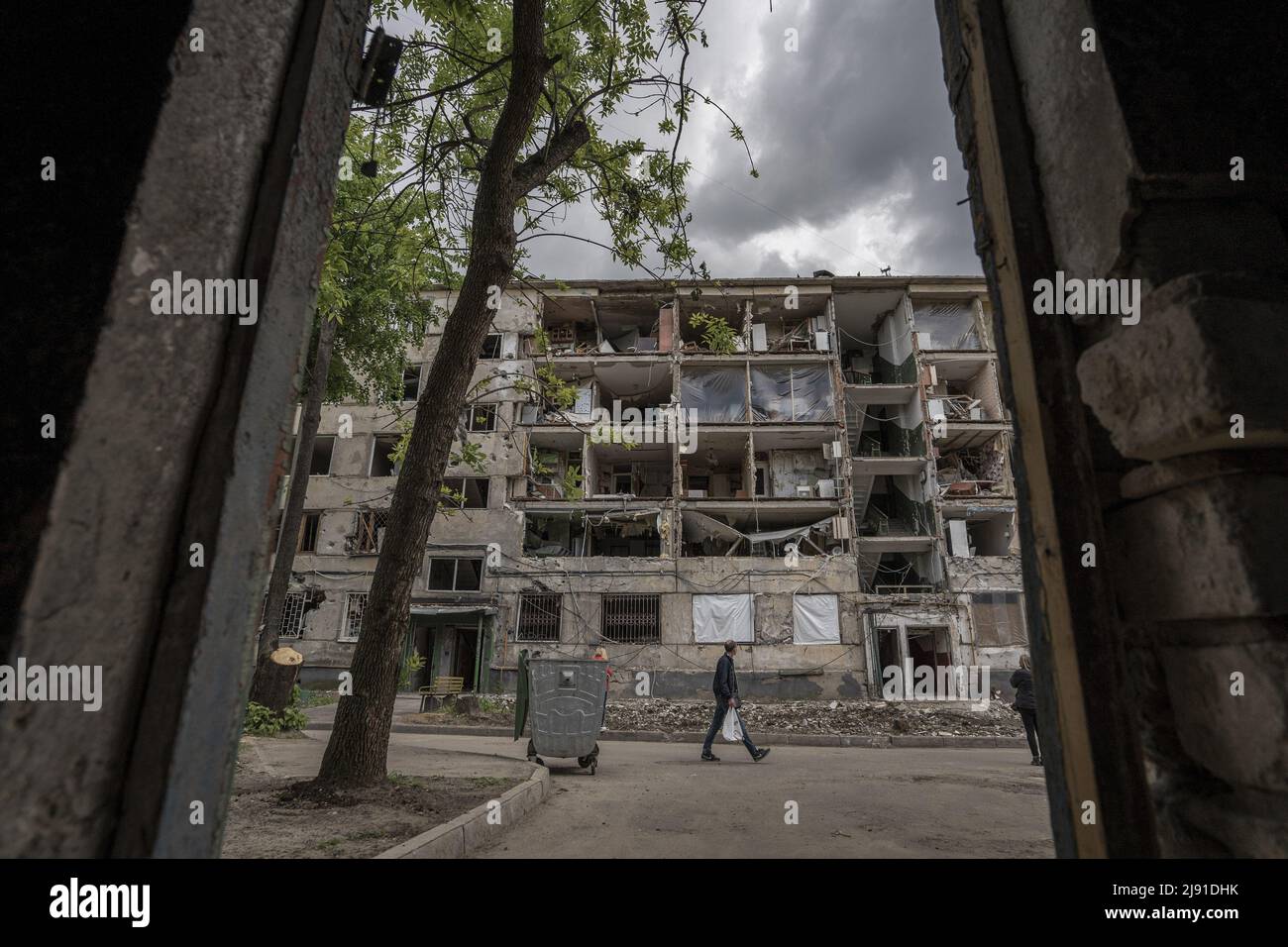 Kharkiv, Ukraine. 19th May, 2022. People walk by the outside of a destroyed apartment building from Russian shelling in Kharkiv, Wednesday, May 18, 2022. Finland and Sweden formally submitted applications to join the NATO military alliance early Wednesday, ending the Nordic nations' decades of military neutrality in the wake of Russia's war in Ukraine. Photo by Ken Cedeno/UPI Credit: UPI/Alamy Live News Stock Photo